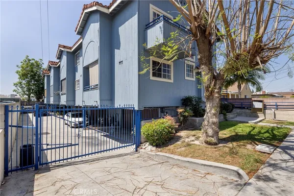 a backyard of a house with barbeque oven and outdoor seating