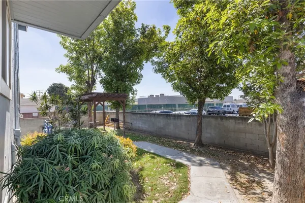 a backyard of a house with a garden and plants