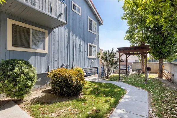a backyard of a house with table and chairs