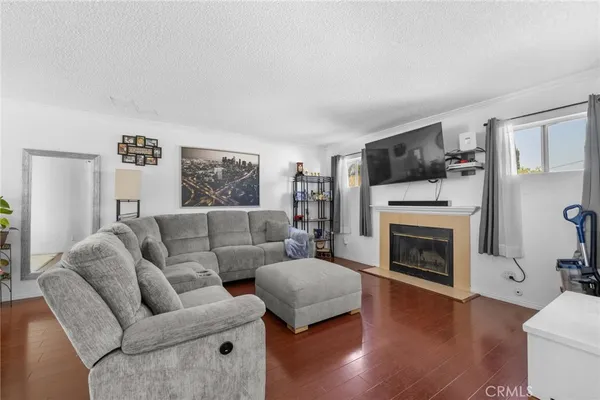 a living room with furniture flat screen tv and a fireplace