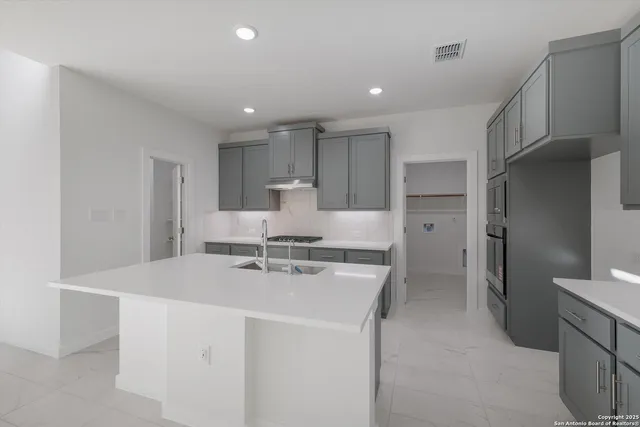 a kitchen that has a sink and a stove