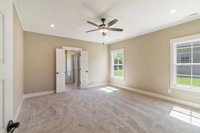 an empty room with closet and windows