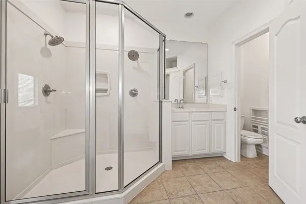 a bathroom with a granite countertop sink mirror and toilet