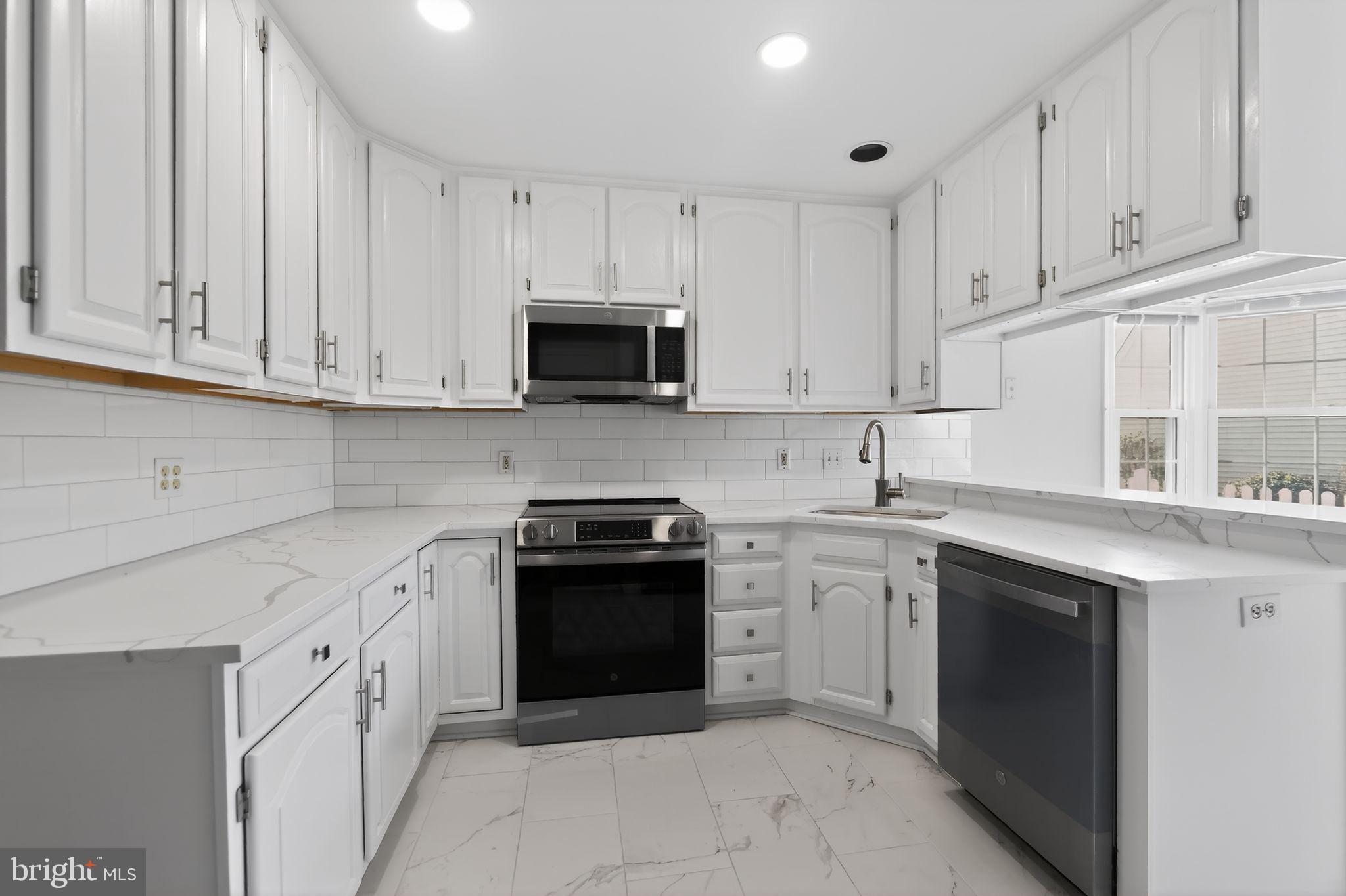 825 Dunbrooke Court Frederick, MD 21701 - Photo 14 of 31 a kitchen with white cabinets stainless steel appliances and sink