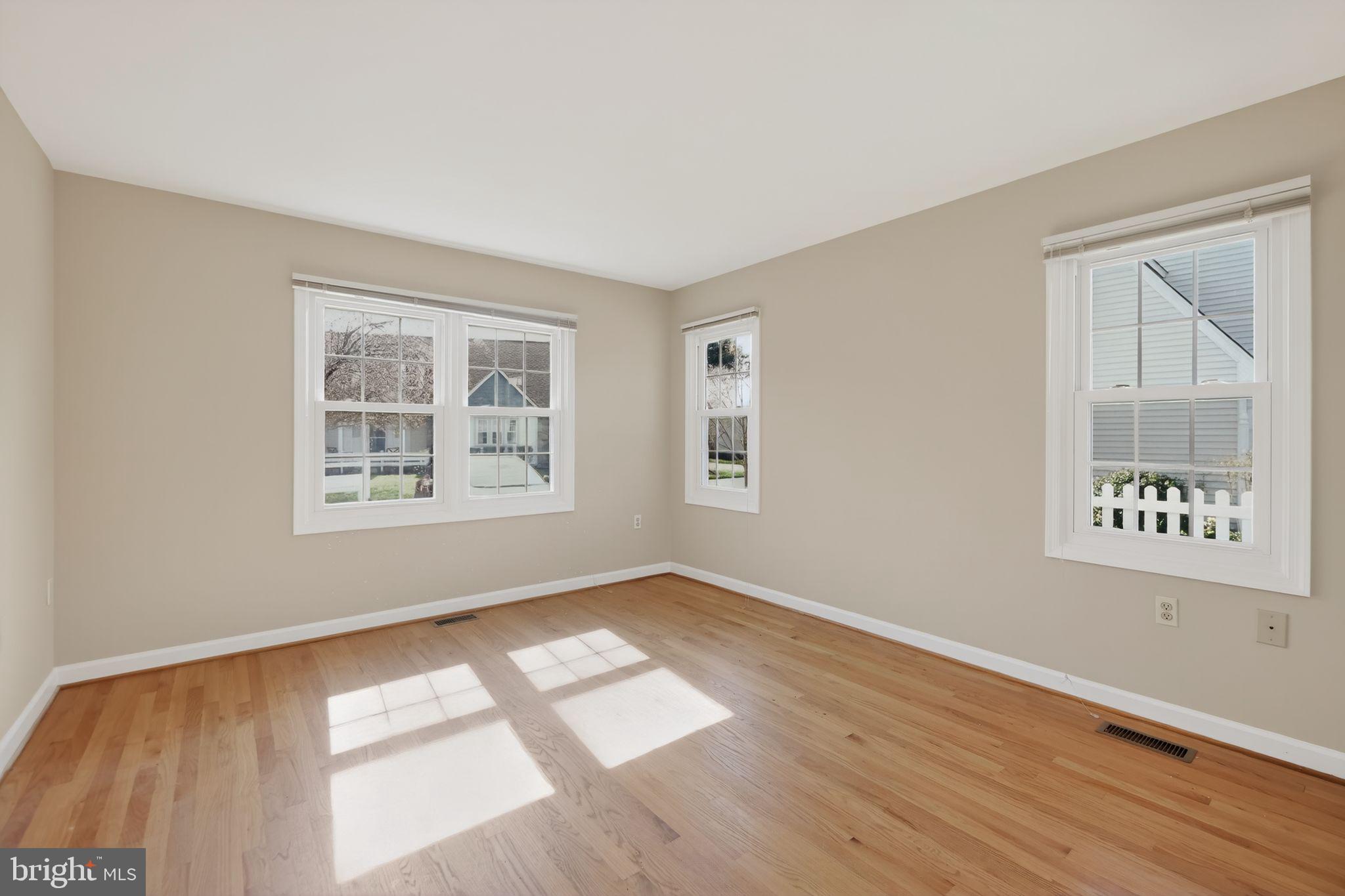 825 Dunbrooke Court Frederick, MD 21701 - Photo 16 of 31 a view of an empty room with window and wooden floor