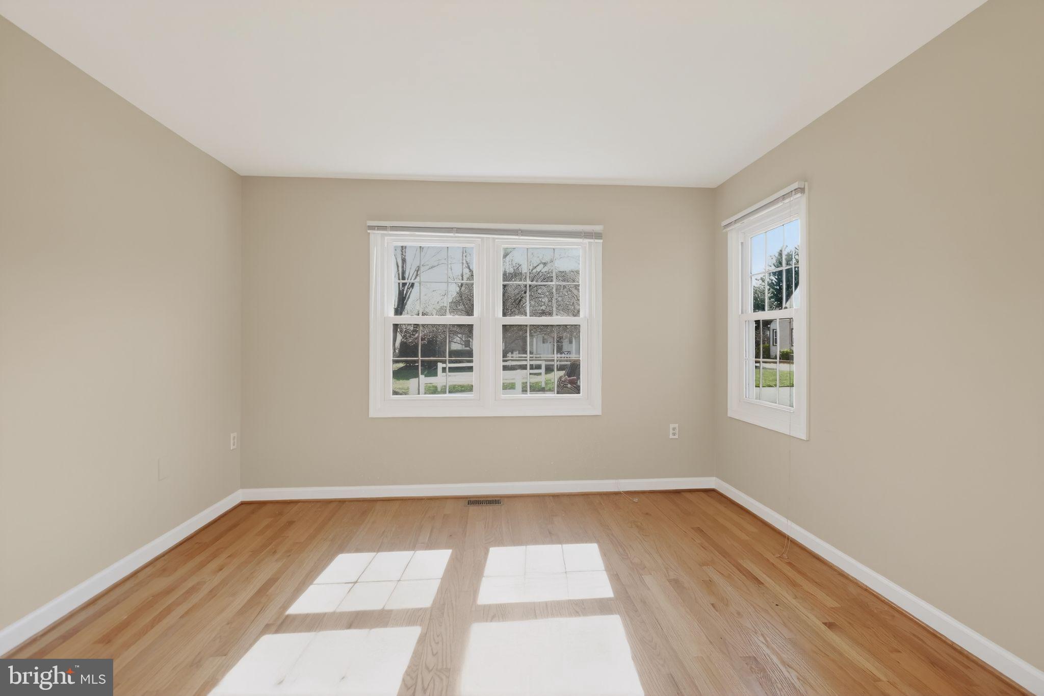 825 Dunbrooke Court Frederick, MD 21701 - Photo 17 of 31 a view of an empty room with wooden floor and a window