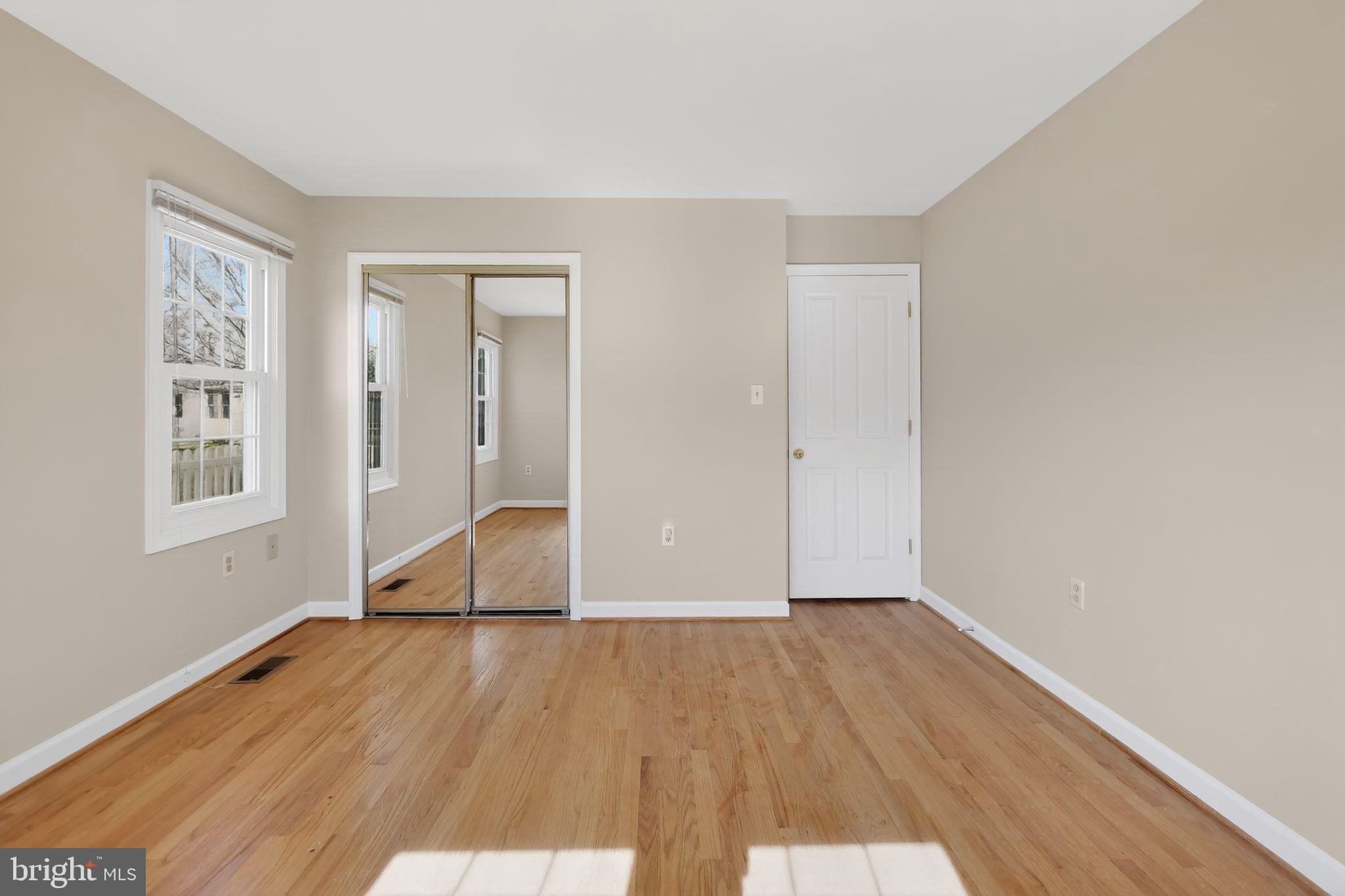 825 Dunbrooke Court Frederick, MD 21701 - Photo 18 of 31 an empty room with wooden floor and windows