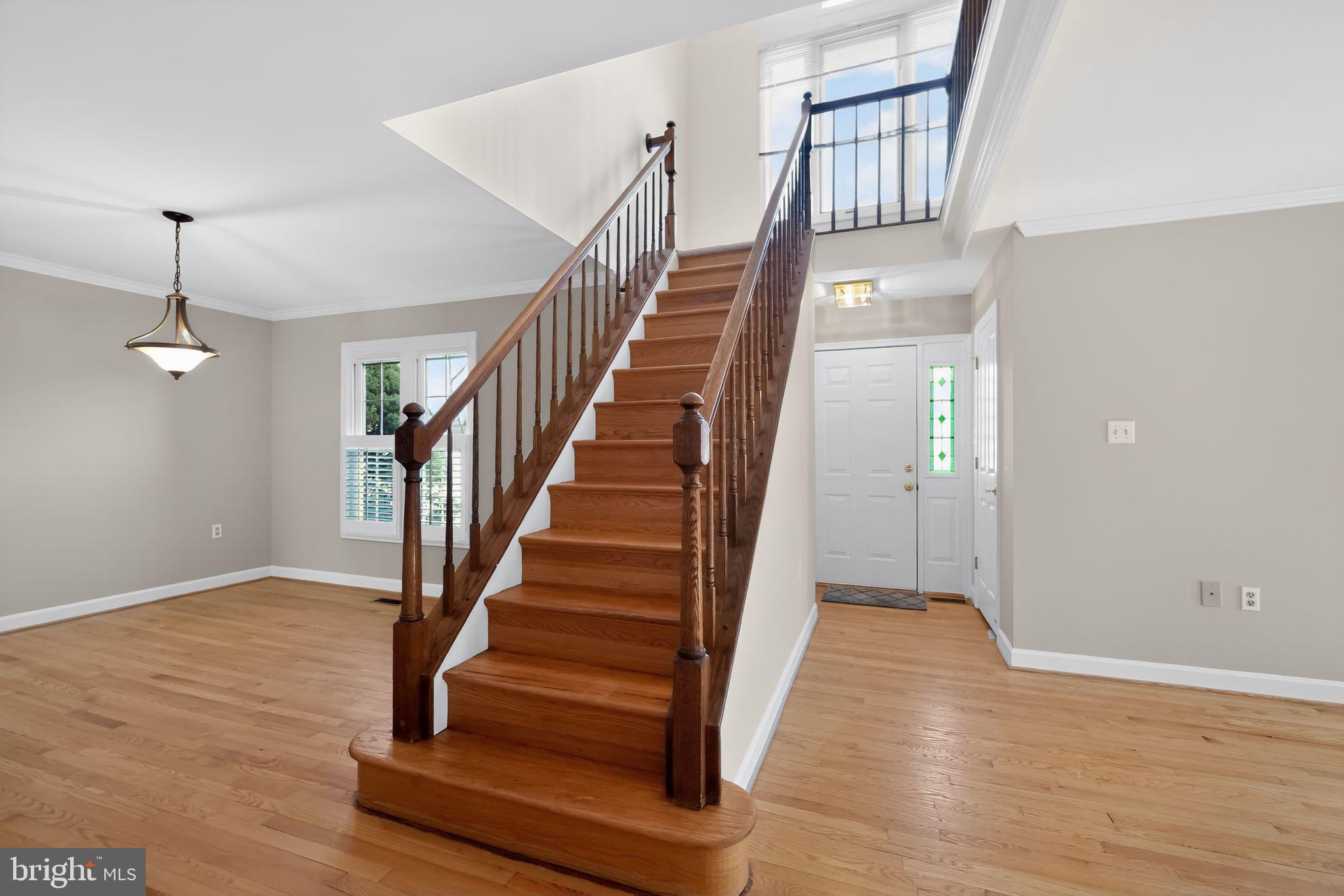 825 Dunbrooke Court Frederick, MD 21701 - Photo 6 of 31 a view of staircase with wooden floor and white walls