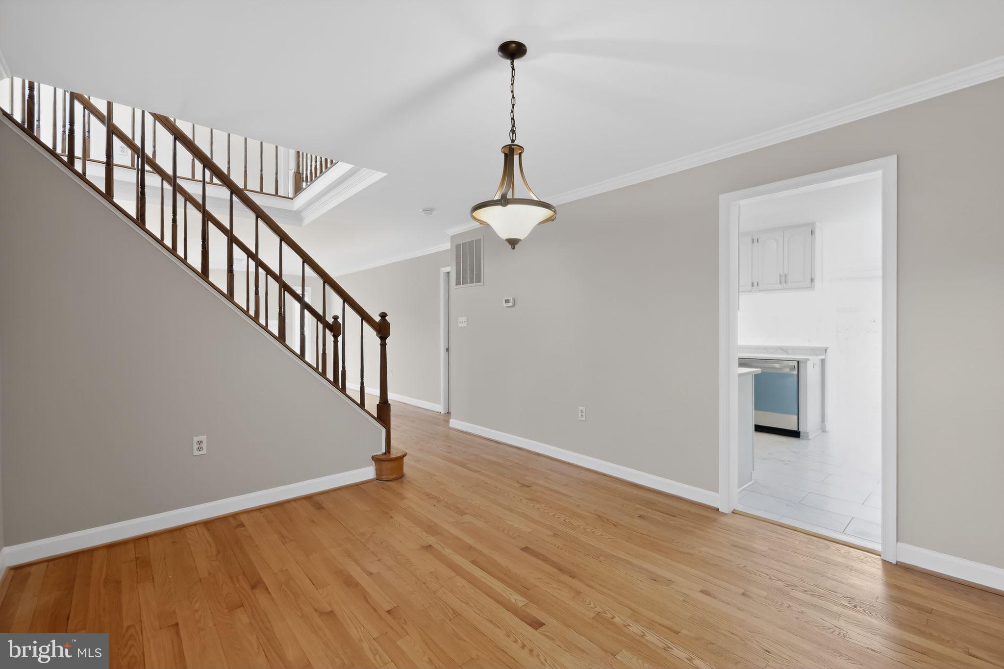 825 Dunbrooke Court Frederick, MD 21701 - Photo 9 of 31 a view of a room with wooden floor ceiling fan and windows