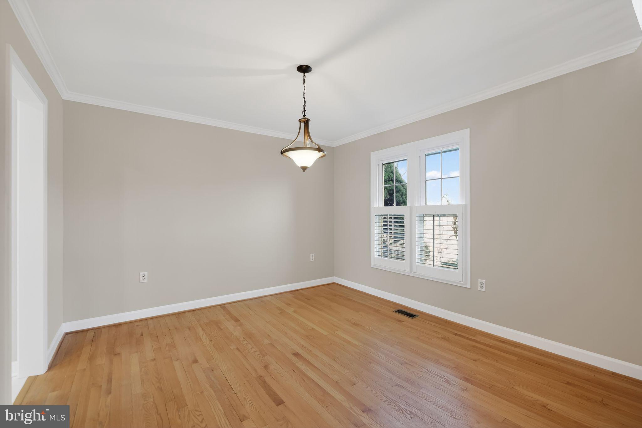825 Dunbrooke Court Frederick, MD 21701 - Photo 10 of 31 a view of empty room with wooden floor and fan
