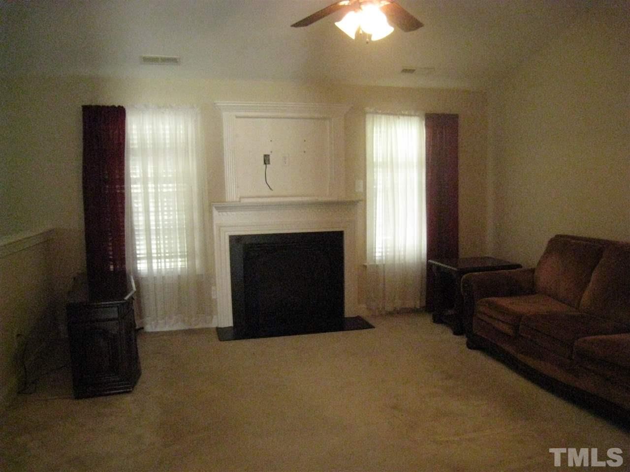 60 Brax Carr Way Angier, NC 27501 - Photo 6 of 14 a living room with furniture and a fireplace
