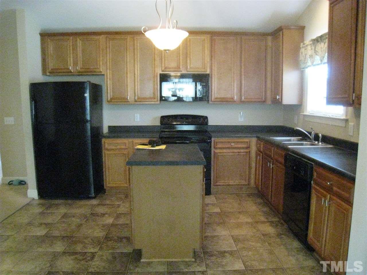 60 Brax Carr Way Angier, NC 27501 - Photo 7 of 14 a kitchen with a sink stove and refrigerator