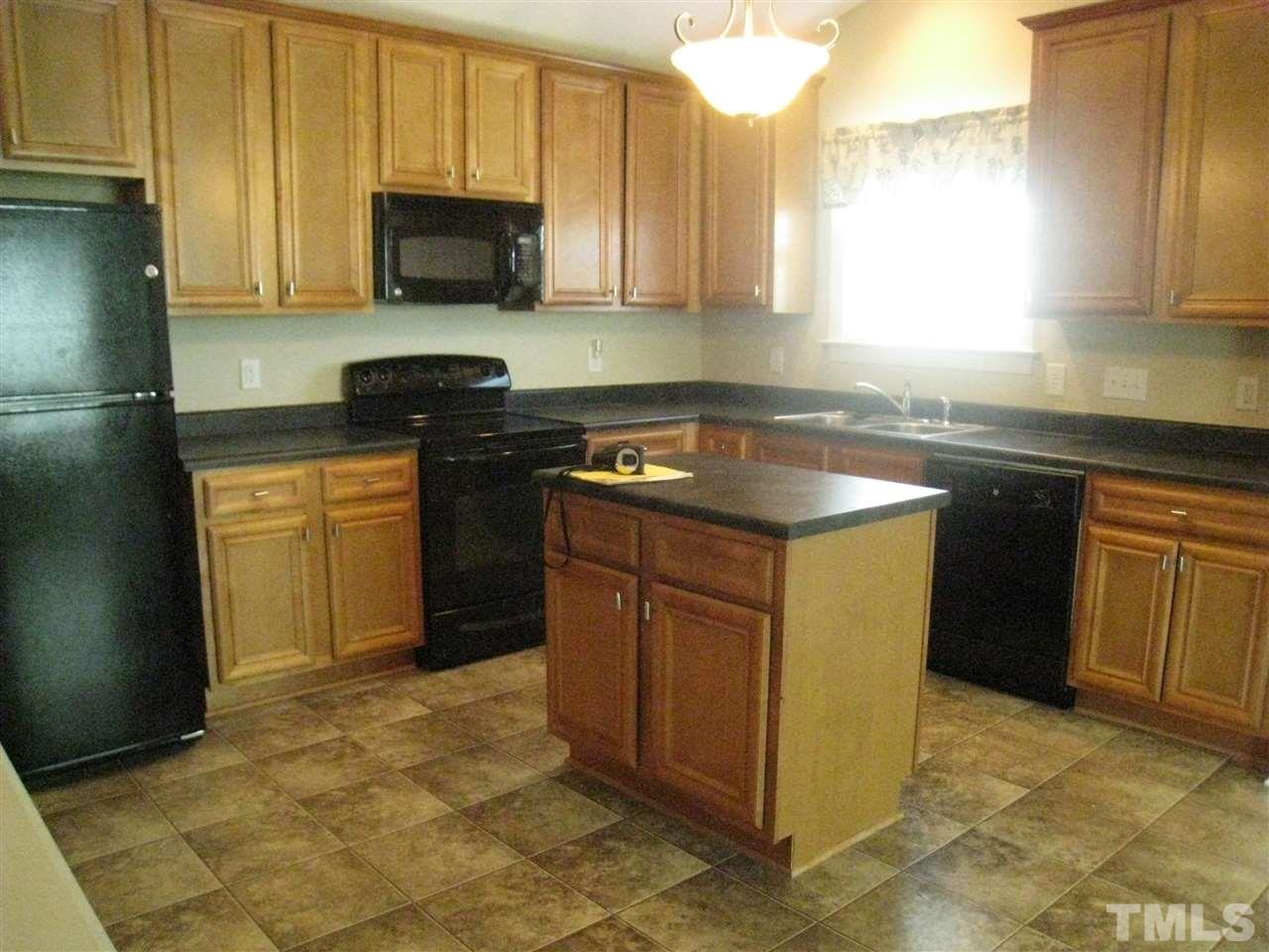 60 Brax Carr Way Angier, NC 27501 - Photo 8 of 14 a kitchen with stainless steel appliances granite countertop a stove a sink and a microwave