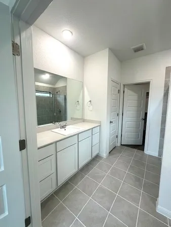 a bathroom with a granite countertop sink mirror and