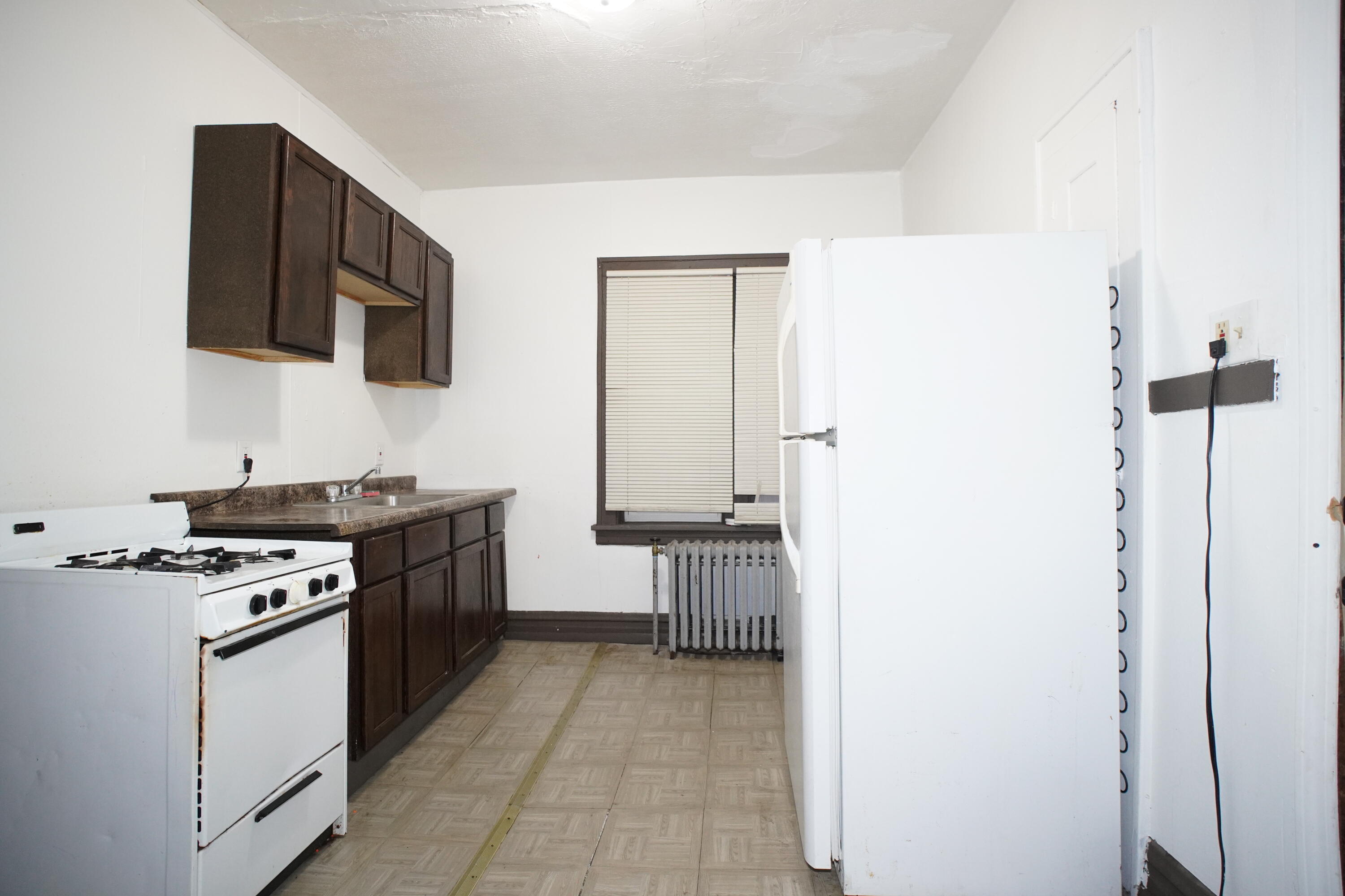 130 East 13th Avenue, Unit 8 Gary, IN 46407 - Photo 14 of 17 a kitchen with a stove and a microwave