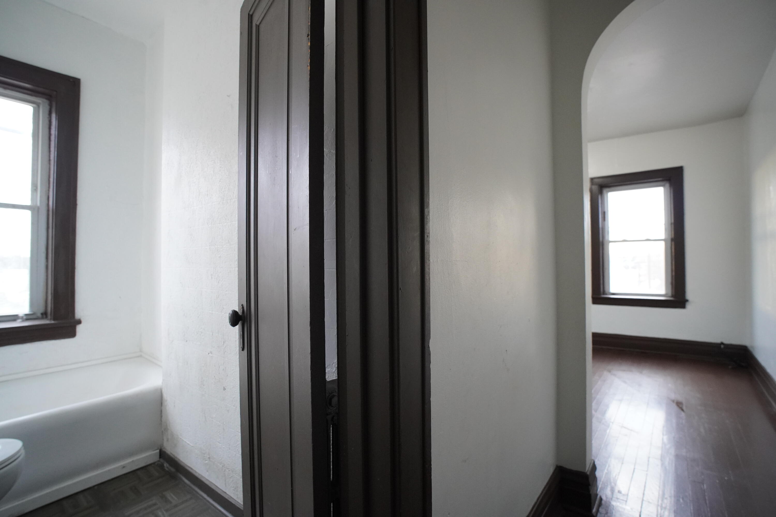 130 East 13th Avenue, Unit 8 Gary, IN 46407 - Photo 2 of 17 a bathroom with a bathtub and a window