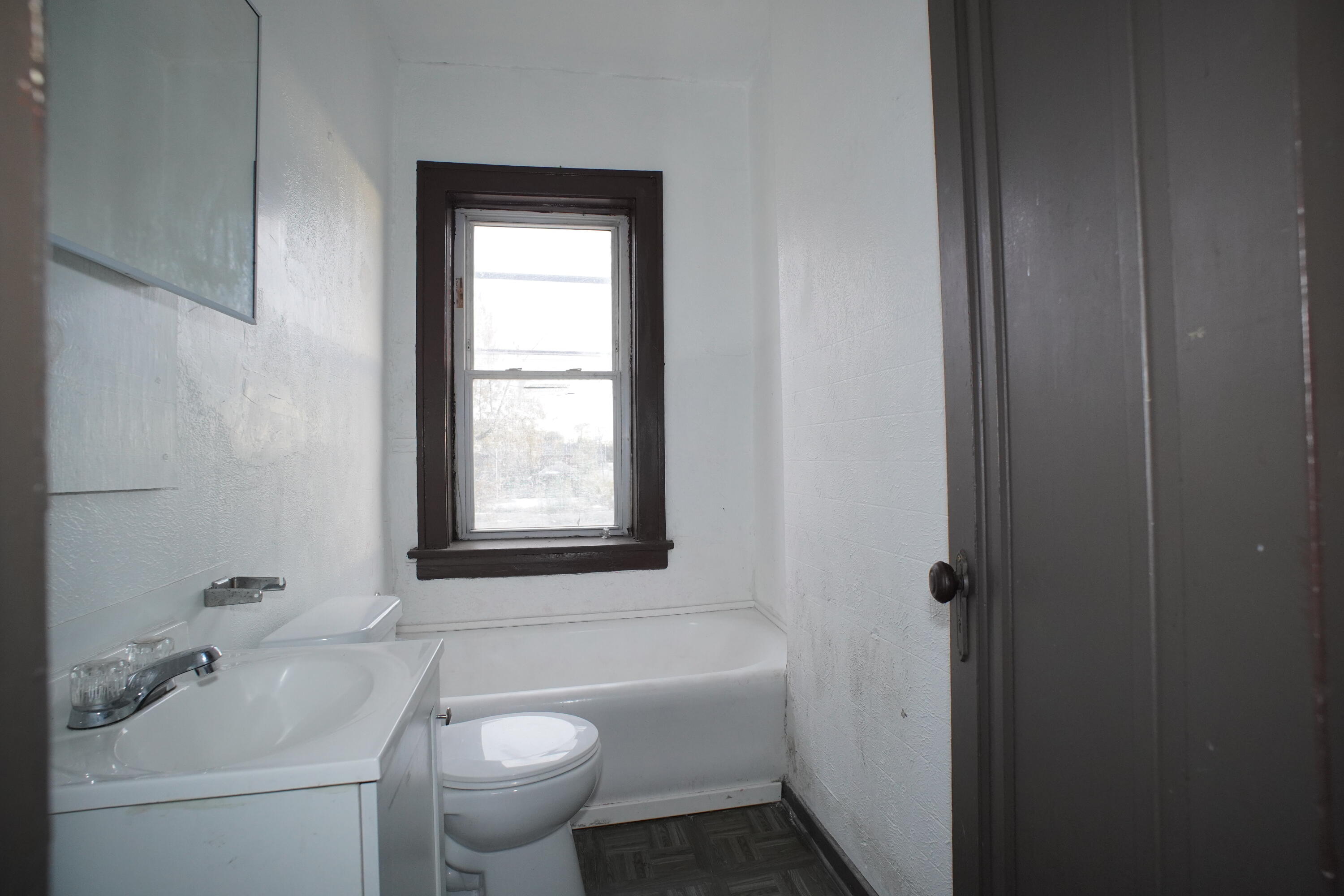 130 East 13th Avenue, Unit 8 Gary, IN 46407 - Photo 5 of 17 a bathroom with a sink toilet and shower