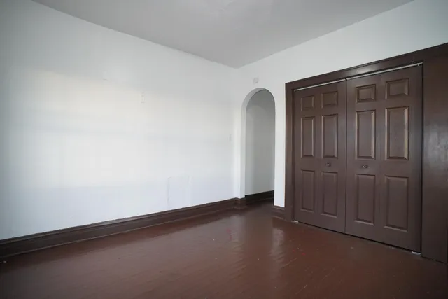 an empty room with closet area