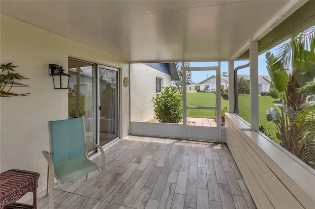 a view of porch with furniture and large windows