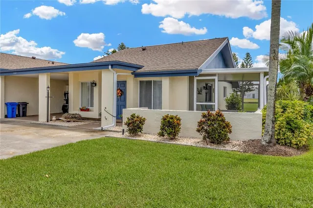 a front view of a house with a garden and plants