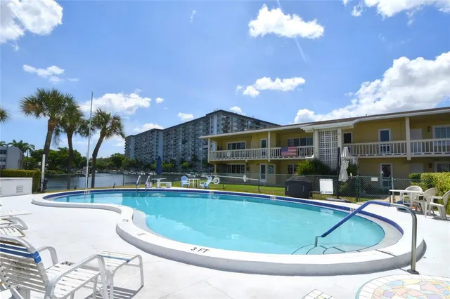 a view of a house with swimming pool and a patio