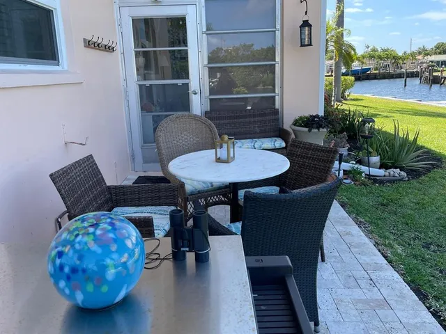 a backyard of a house with table and chairs
