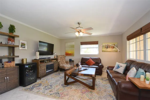 a living room with furniture flat screen tv and window