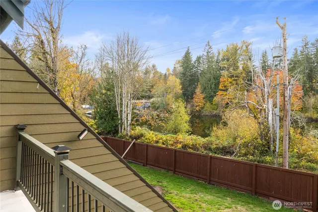 a view of a balcony with wooden floor and fence