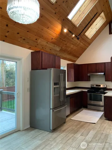 a kitchen with stainless steel appliances granite countertop a refrigerator and a stove top oven