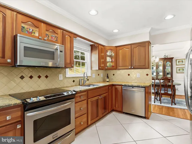a kitchen with stainless steel appliances granite countertop a refrigerator sink and cabinets