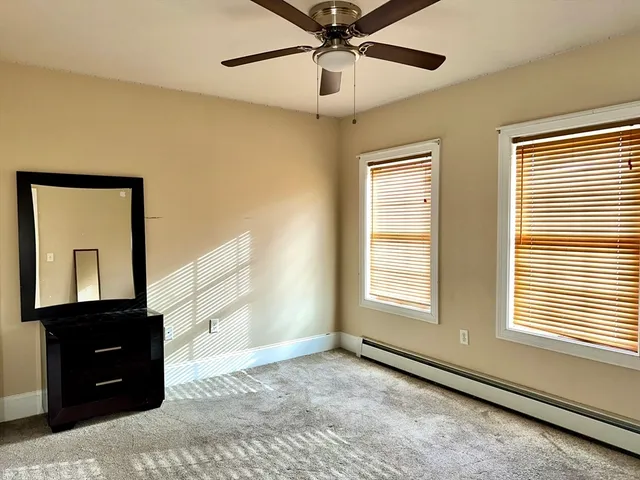 a bathroom with a granite countertop sink toilet and a mirror