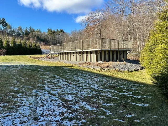 a view of a house with a yard and furniture