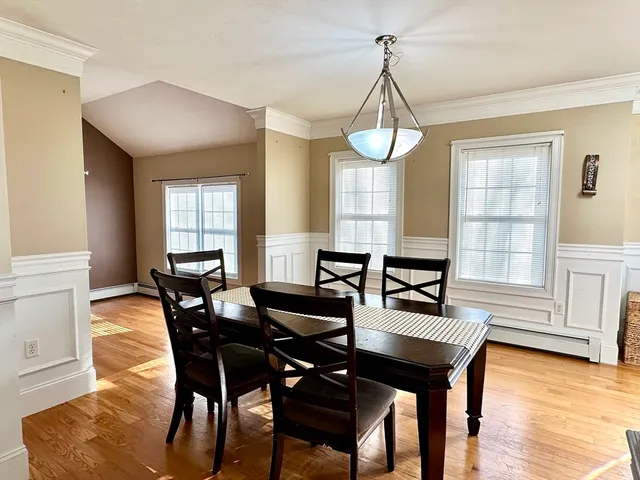 a view of a dining room with furniture window and wooden floor