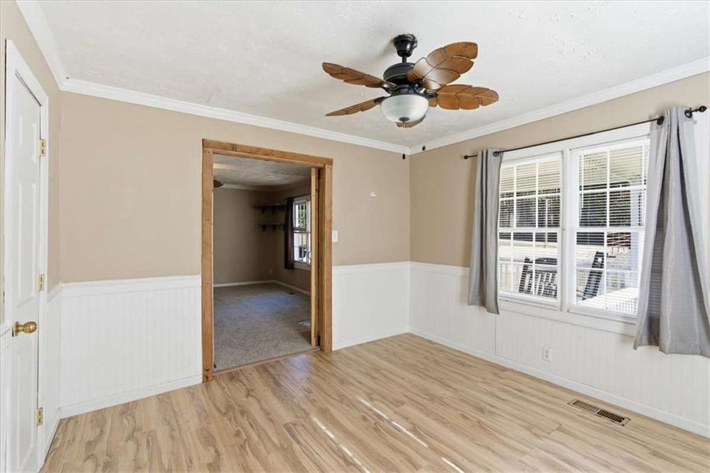 587 Whooping Creek Road Carrollton, GA 30116 - Photo 29 of 38 a view of empty room with wooden floor and ceiling fan