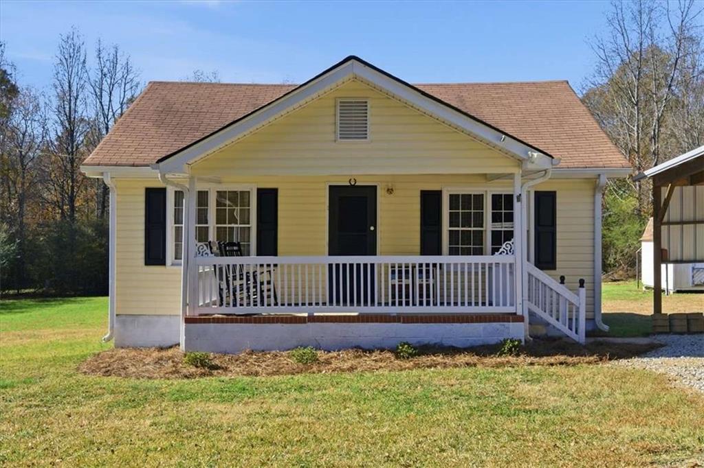 587 Whooping Creek Road Carrollton, GA 30116 - Photo 8 of 38 a front view of a house with a garden