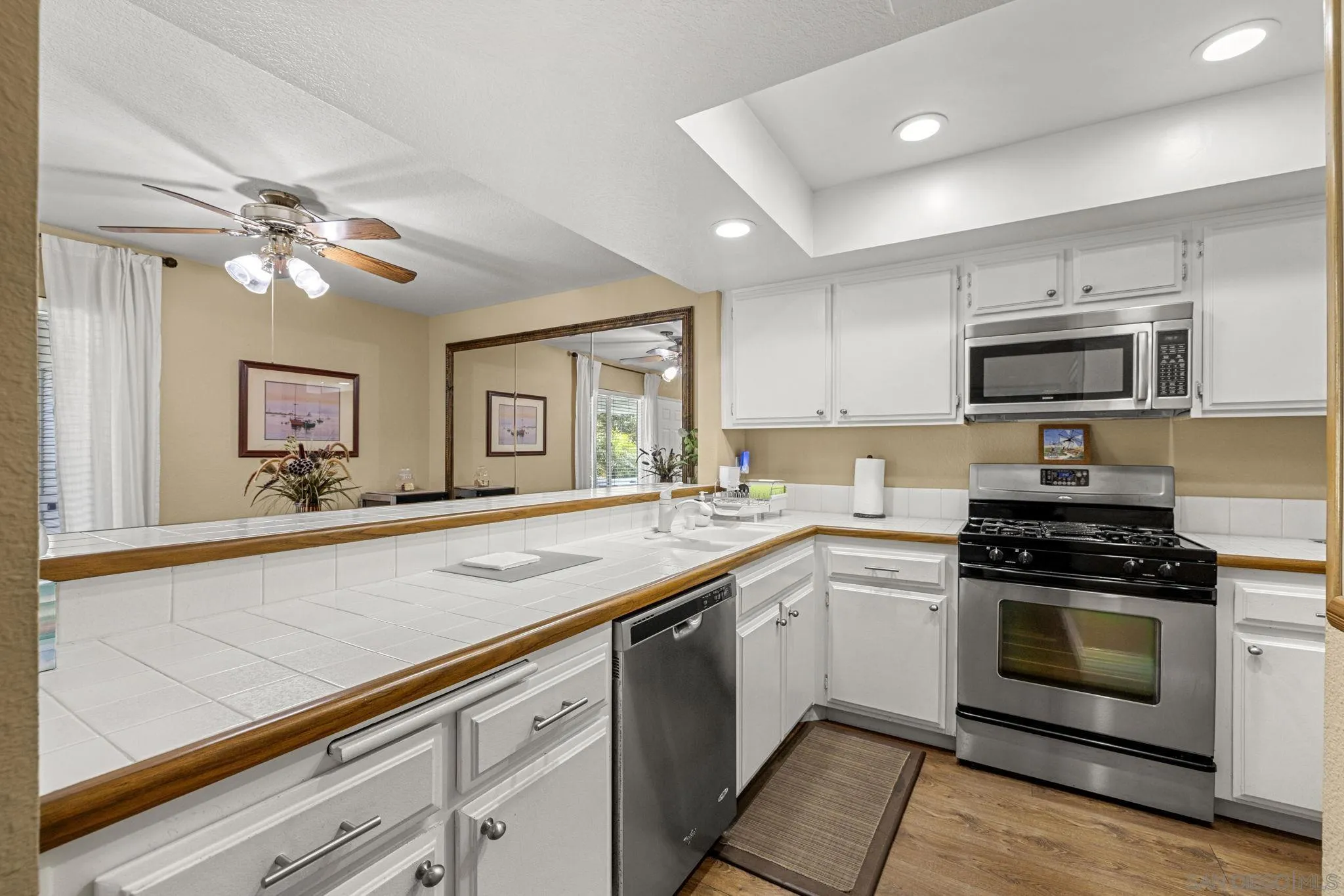 883 Ginger Avenue Carlsbad, CA 92011 - Photo 12 of 33 a kitchen with a sink stove and microwave