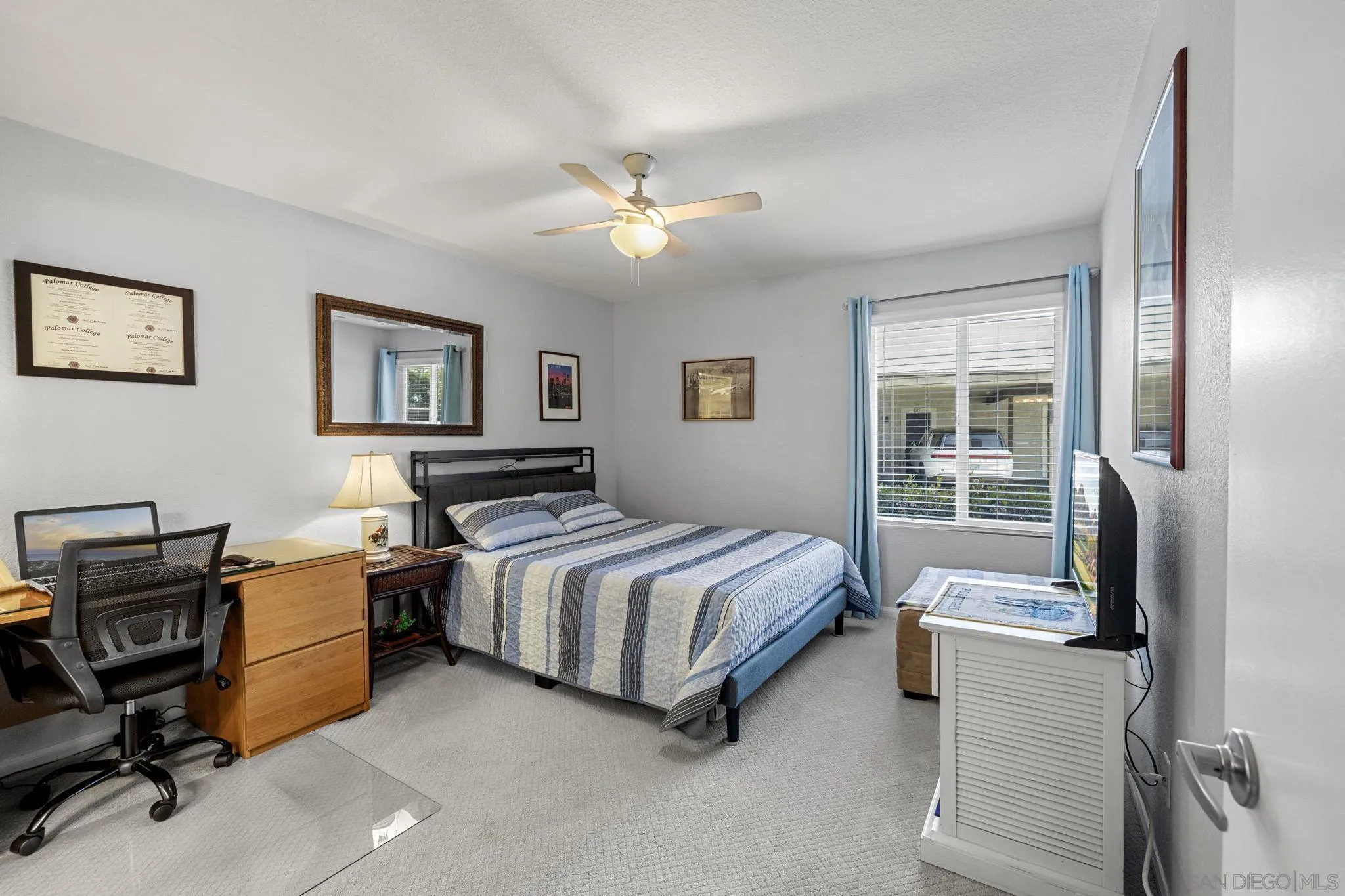 883 Ginger Avenue Carlsbad, CA 92011 - Photo 15 of 33 a bedroom with a bed and a chandelier
