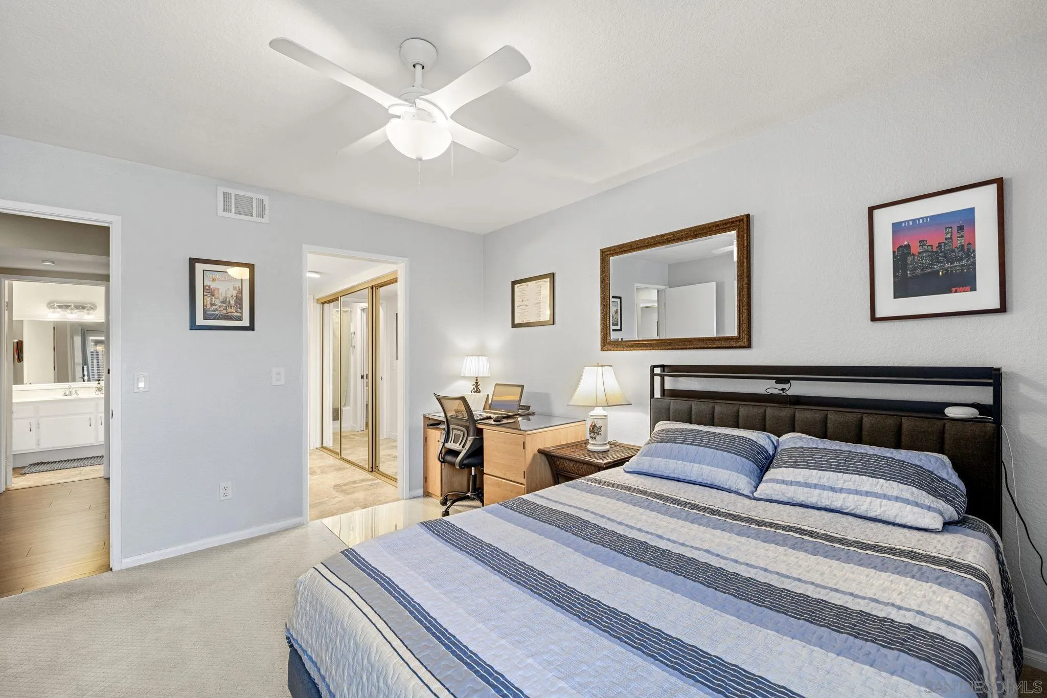 883 Ginger Avenue Carlsbad, CA 92011 - Photo 16 of 33 a bedroom with a large bed and a chandelier