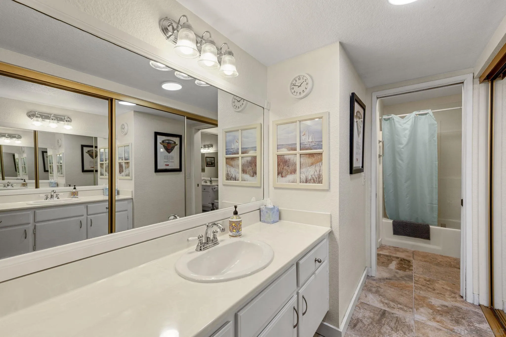 883 Ginger Avenue Carlsbad, CA 92011 - Photo 17 of 33 a spacious bathroom with a granite countertop sink mirror and shower