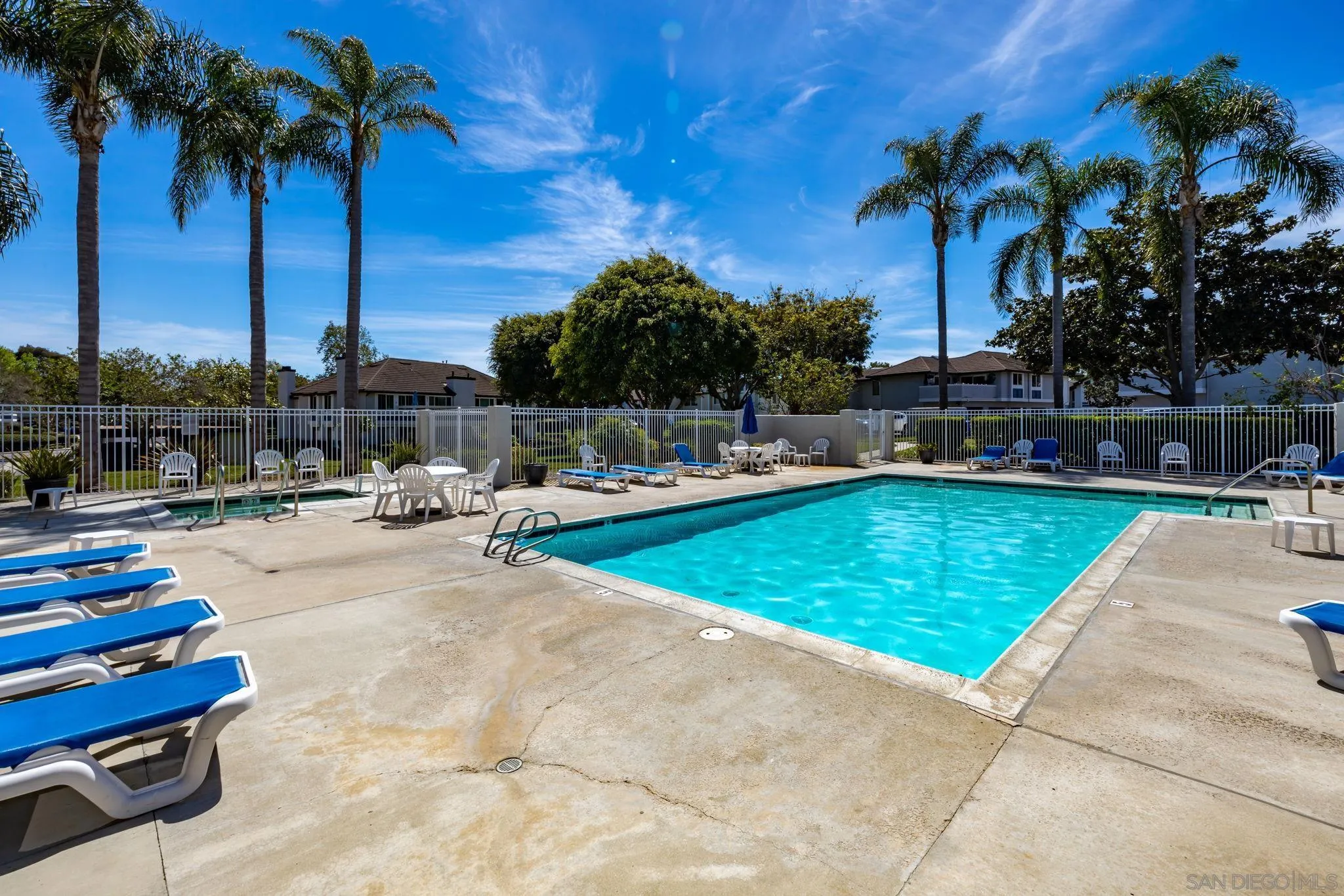 883 Ginger Avenue Carlsbad, CA 92011 - Photo 27 of 33 a swimming pool with outdoor seating and palm tree