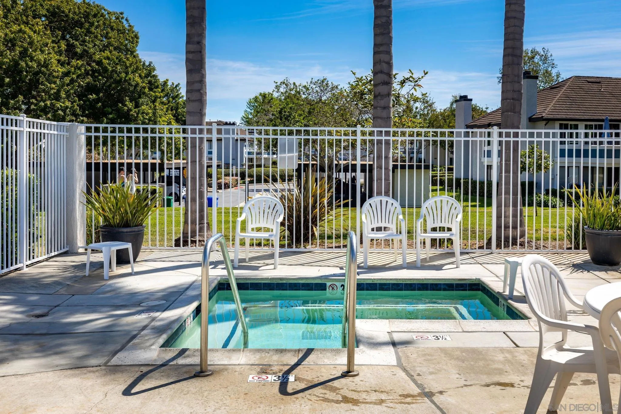 883 Ginger Avenue Carlsbad, CA 92011 - Photo 30 of 33 a view of a patio with a table chairs and a floor to ceiling window