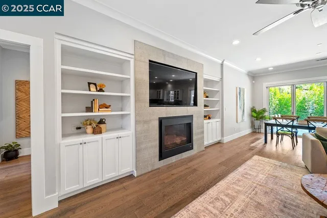 a living room with furniture a flat screen tv and a fireplace