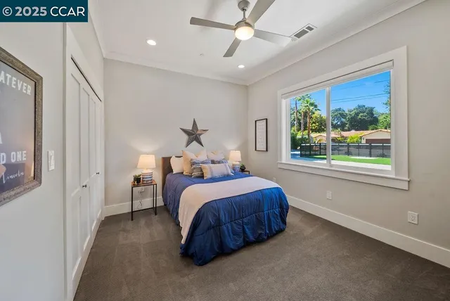 a bed room with a bed and a large window