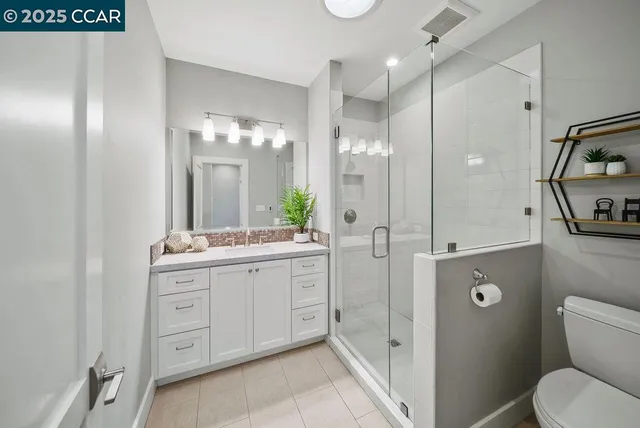 a spacious bathroom with a granite countertop sink mirror and shower