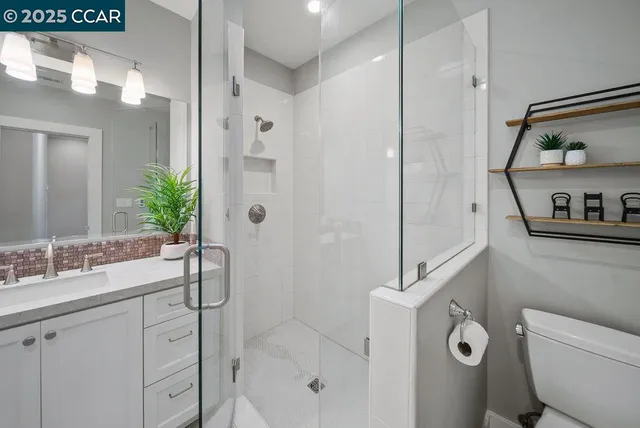 a bathroom with a shower sink and mirror