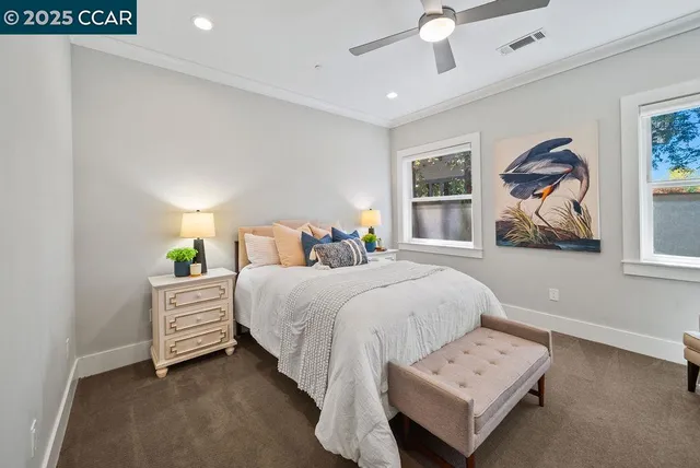 a bedroom with a bed and a painting on the wall