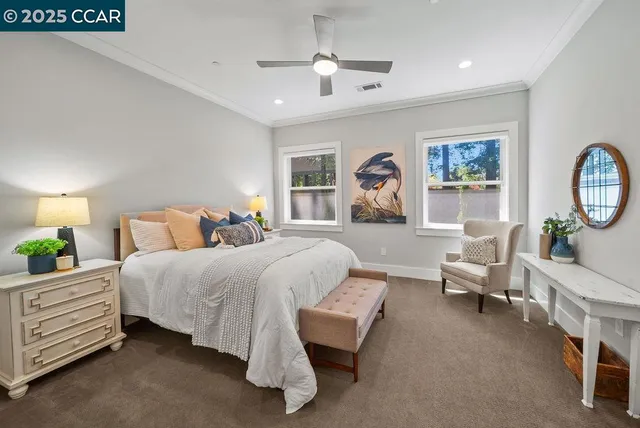a spacious bedroom with a bed a dresser and window
