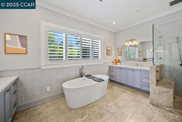 a bathroom with a tub a sink a mirror and a bathtub