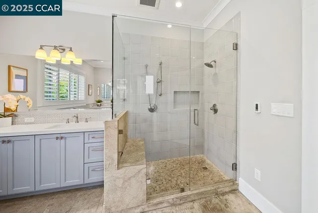 a bathroom with a shower sink and mirror