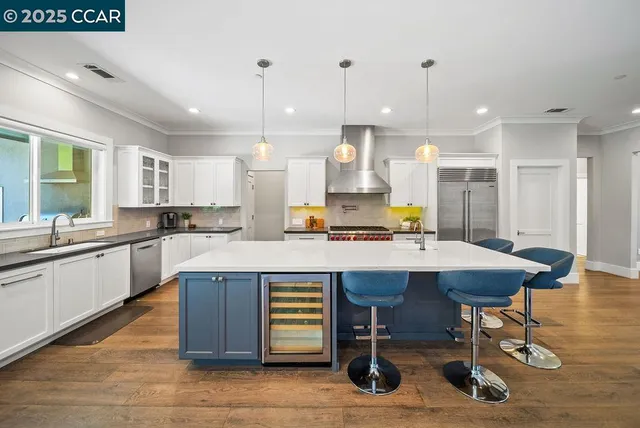a kitchen with a table chairs sink and cabinets